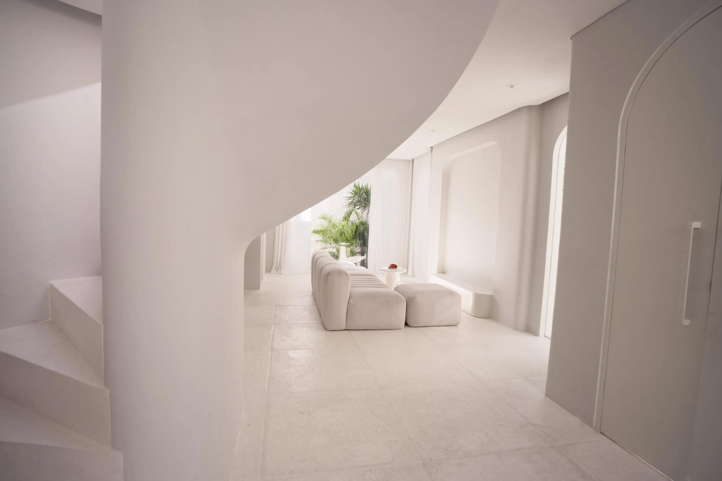 Sculptural white staircase and living space: byduran spaces and architecture