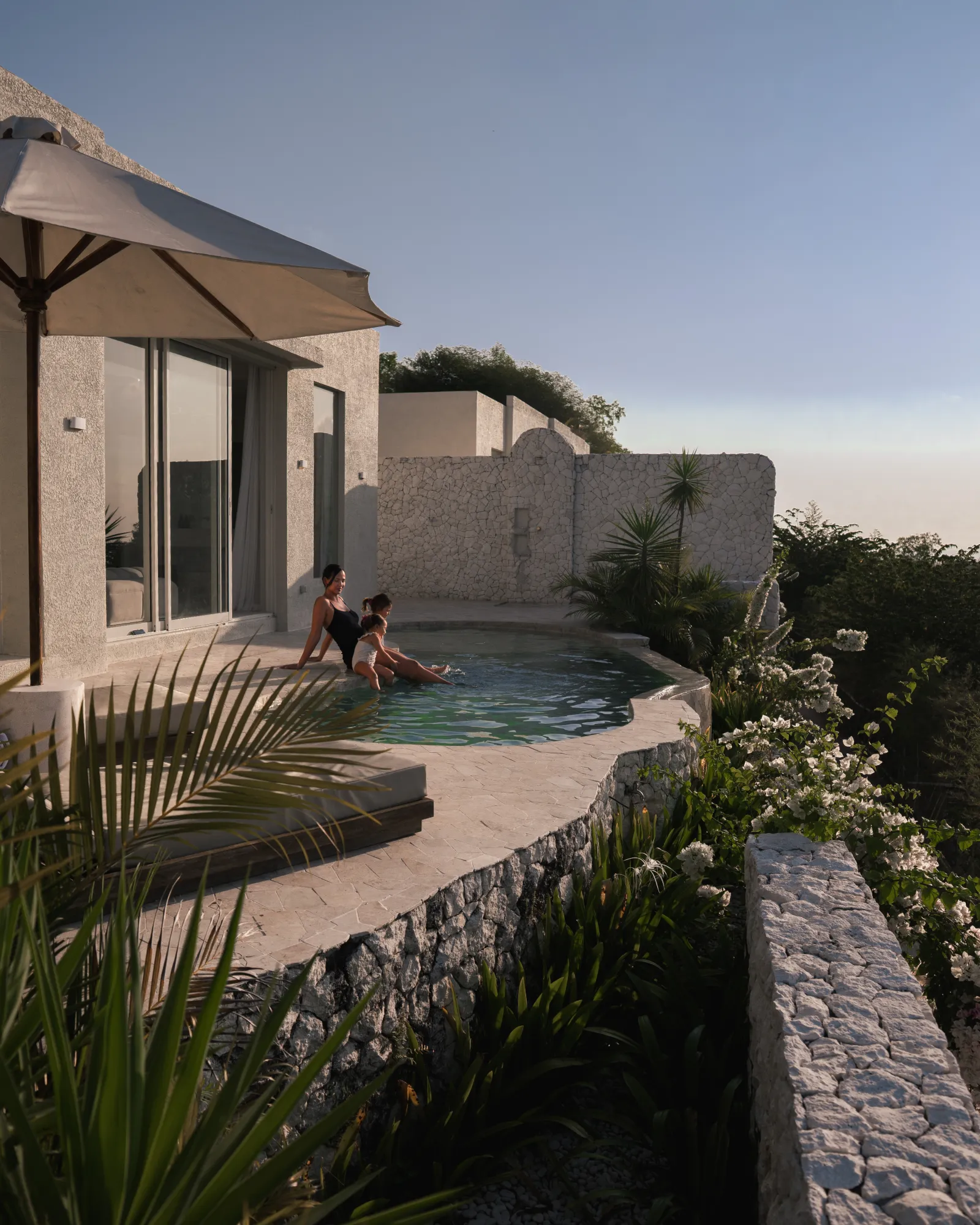 Mother and daughter at an infinity pool