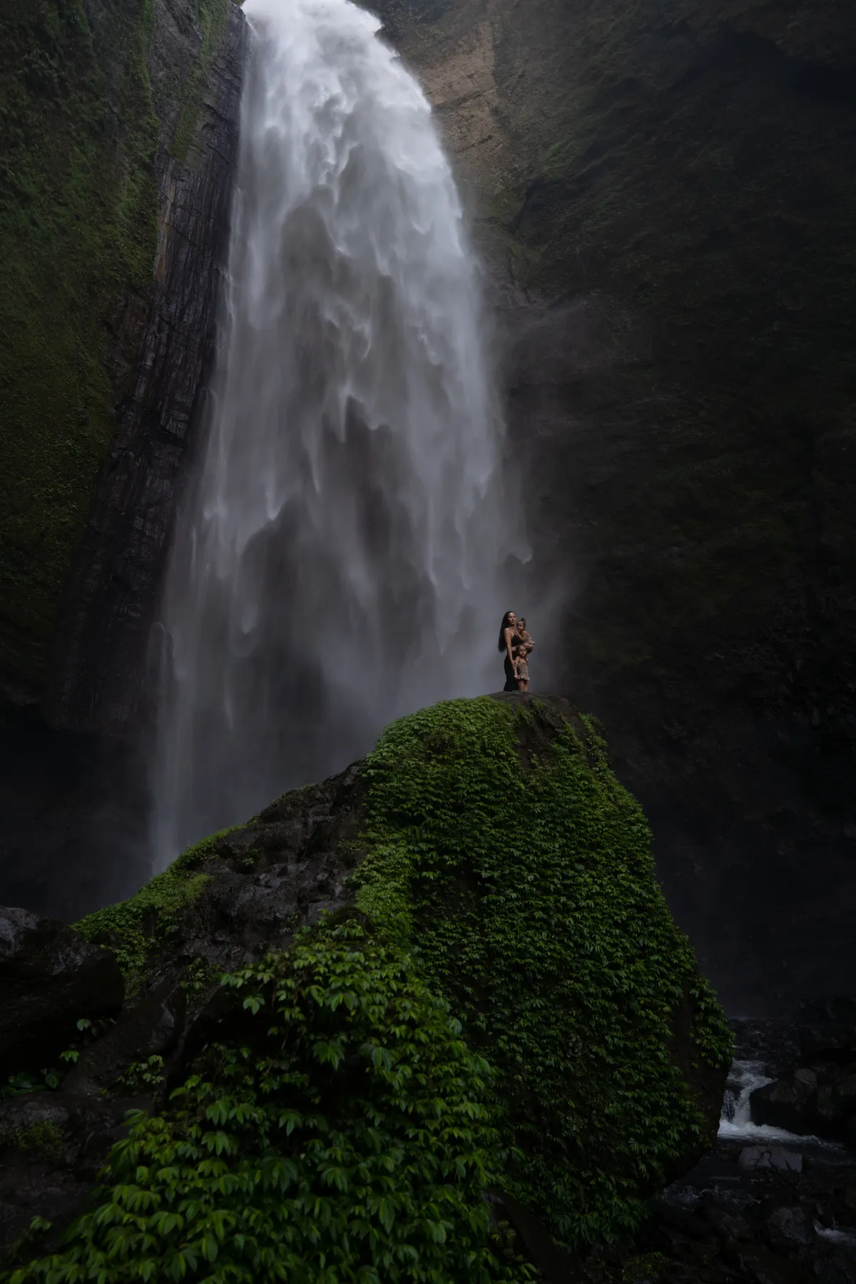 Sense of Place photography: waterfall, distant figures on a mossy ledge